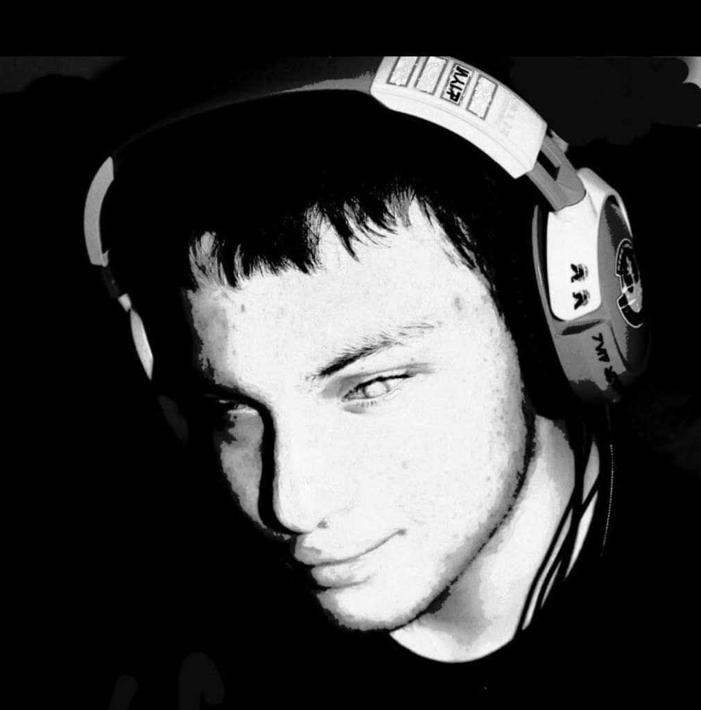 A close-up, black and white shot of TJ the Blind Gamer wearing headphones and focusing on a game.