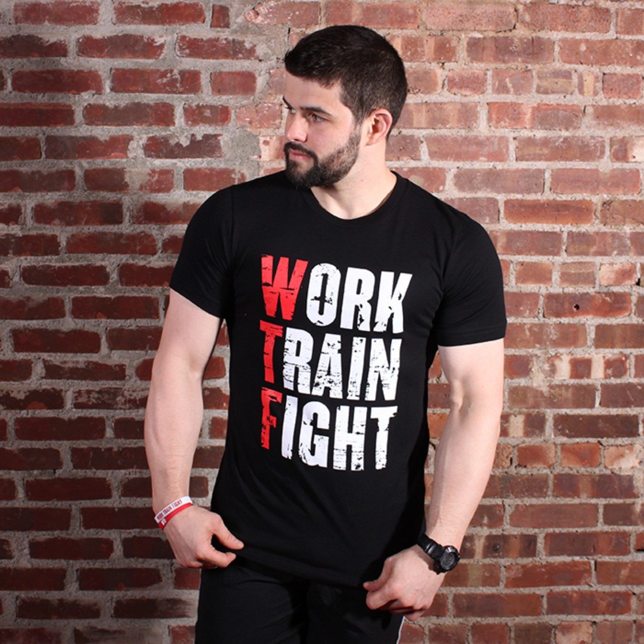 Mark Sayer, fitness trainer, wearing a shirt that says: Work Train Fight