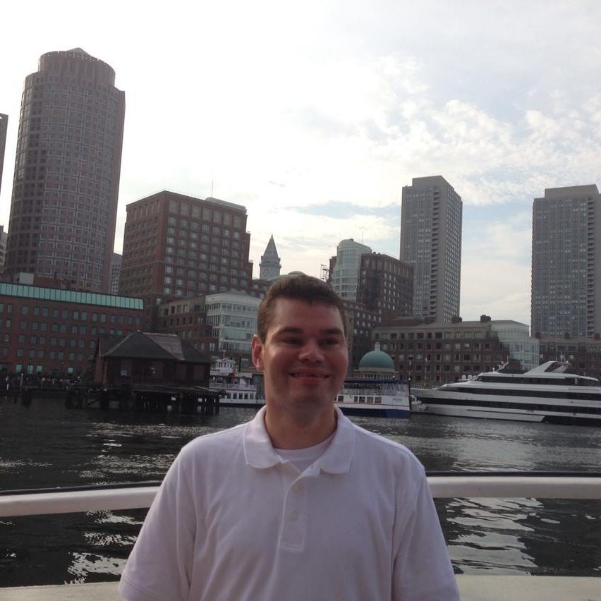 Tim Vernon smiling in front of the Boston skyline