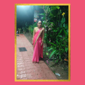 Dilani Sandamali stands on a lush garden path wearing a bright pink and gold sari