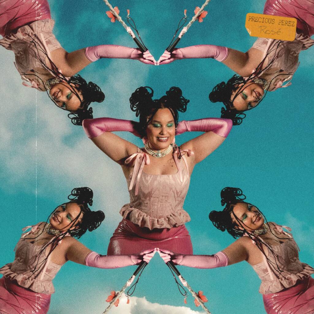 A photo that creates a kaleidoscope effect with five images of Precious. In the center image, she looks chill with her hands behind her head. In the four "reflected" images, she's smiling and holding her white mobility cane. In all images, she's wearing a pink sleeveless top with ruffles and a bow, pink gloves that reach up to her elbows, and a pink skirt. Her dark hair is in box braids styled in buns, and she's wearing vibrant makeup with green eyeshadow. In the top right corner of the photo, there is a yellow label with the text "Precious Perez" and below it, the word "Rosé" in a cursive font.