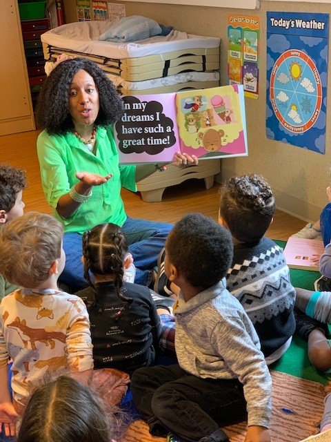 Author and founder of Inside Ability Books Krystle Boateng hosts an accessible story time, reading one of her large-print books to a group of children